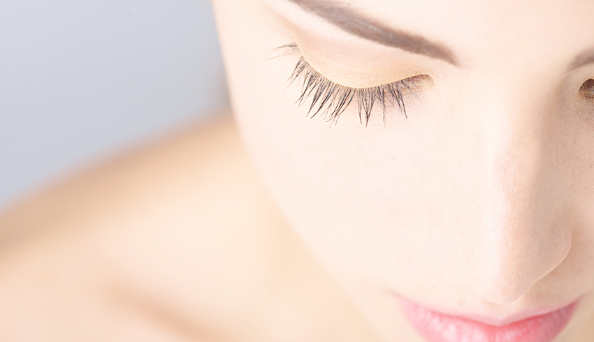 A woman with bright eyes and long lashes